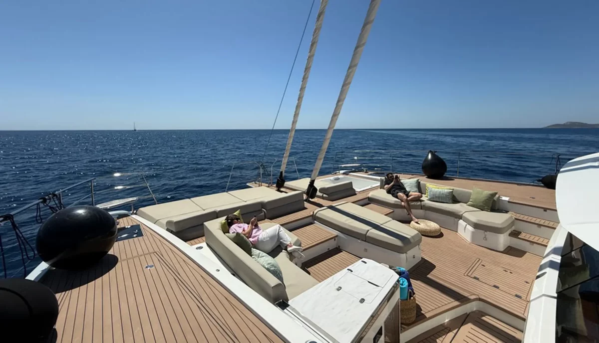 Guests lounging on the foredeck of Ad Astra FP 80 underway