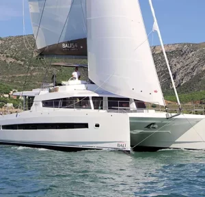 DIDYMOS catamaran sailing in open waters with sails fully raised.
