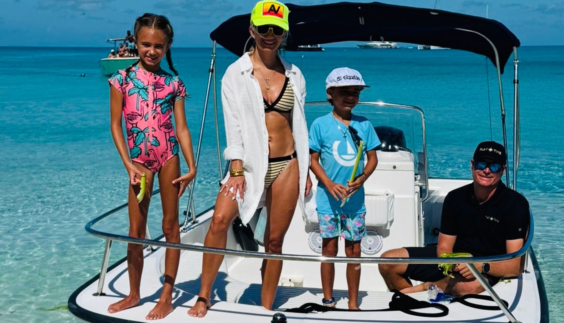 Family with professional captain on deck during captain-only yacht charter