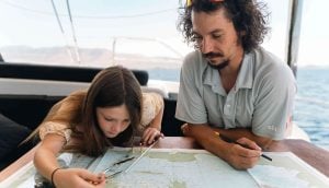 Licensed captain teaching guest navigation on yacht during captain-only charter