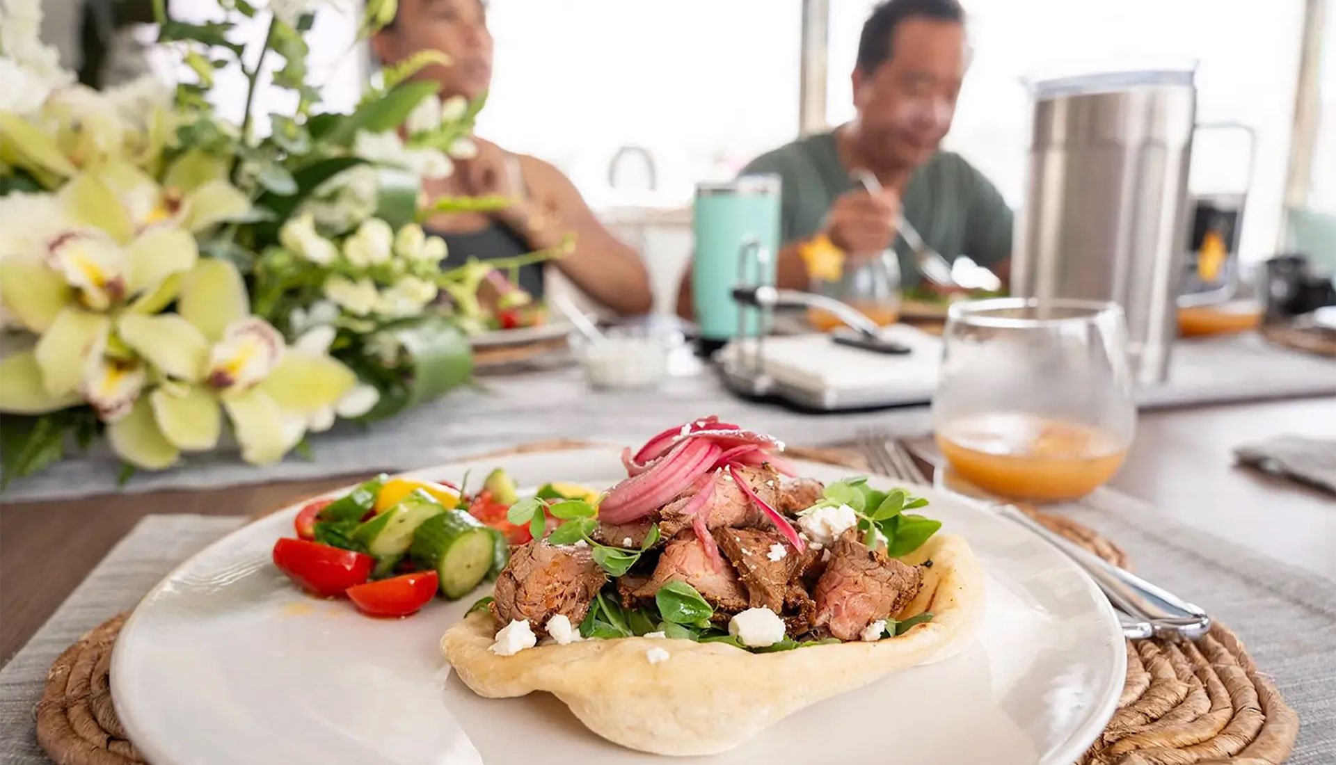 Plated gourmet meal with salad served on board luxury catamaran