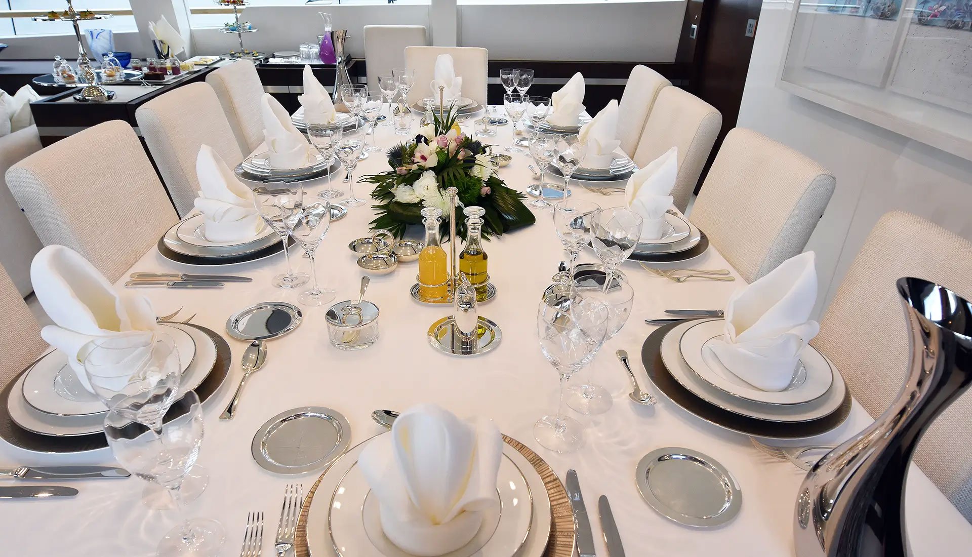 Formal indoor dining table set for a luxury yacht charter meal