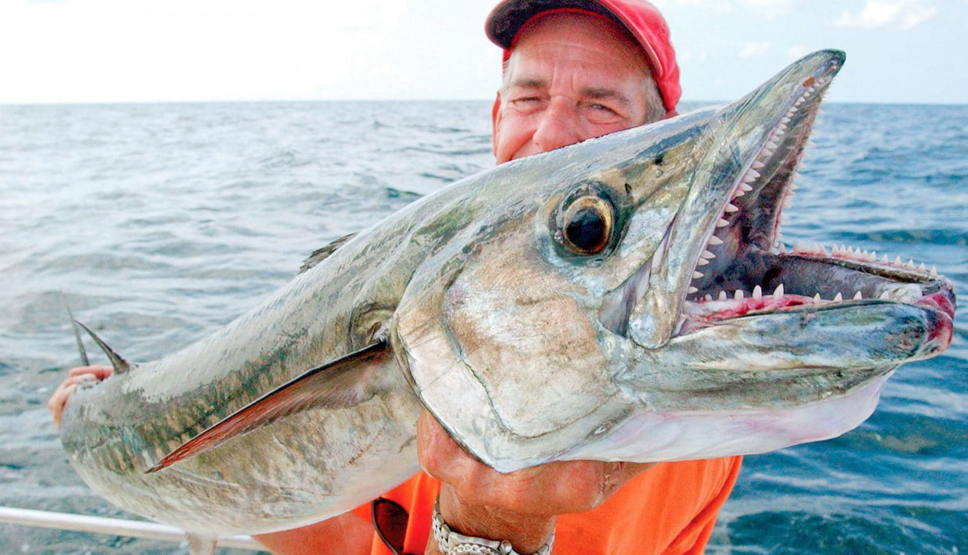 Angler holding a large kingfish on a yacht in the Virgin Islands.