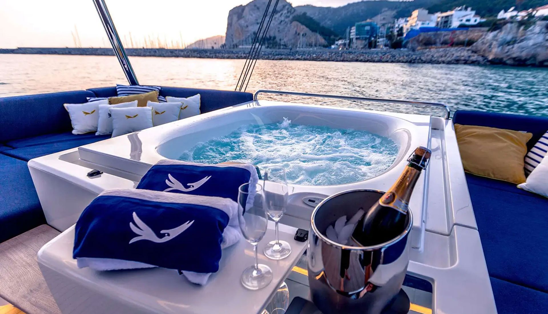 Luxury yacht dining experience with champagne served beside the Jacuzzi