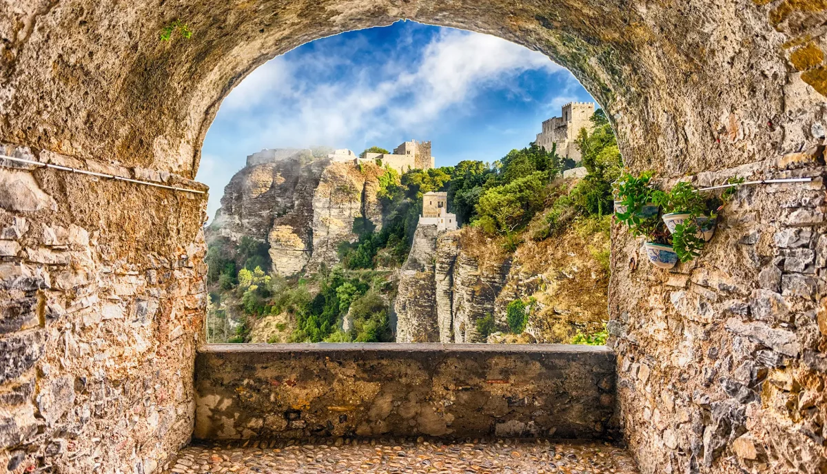 Medieval hilltop town of Erice viewed through stone archway Trapani Sicily