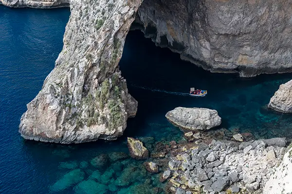Blue Grotto entrance in Capri with tourist boats waiting to enter the famous sea cave