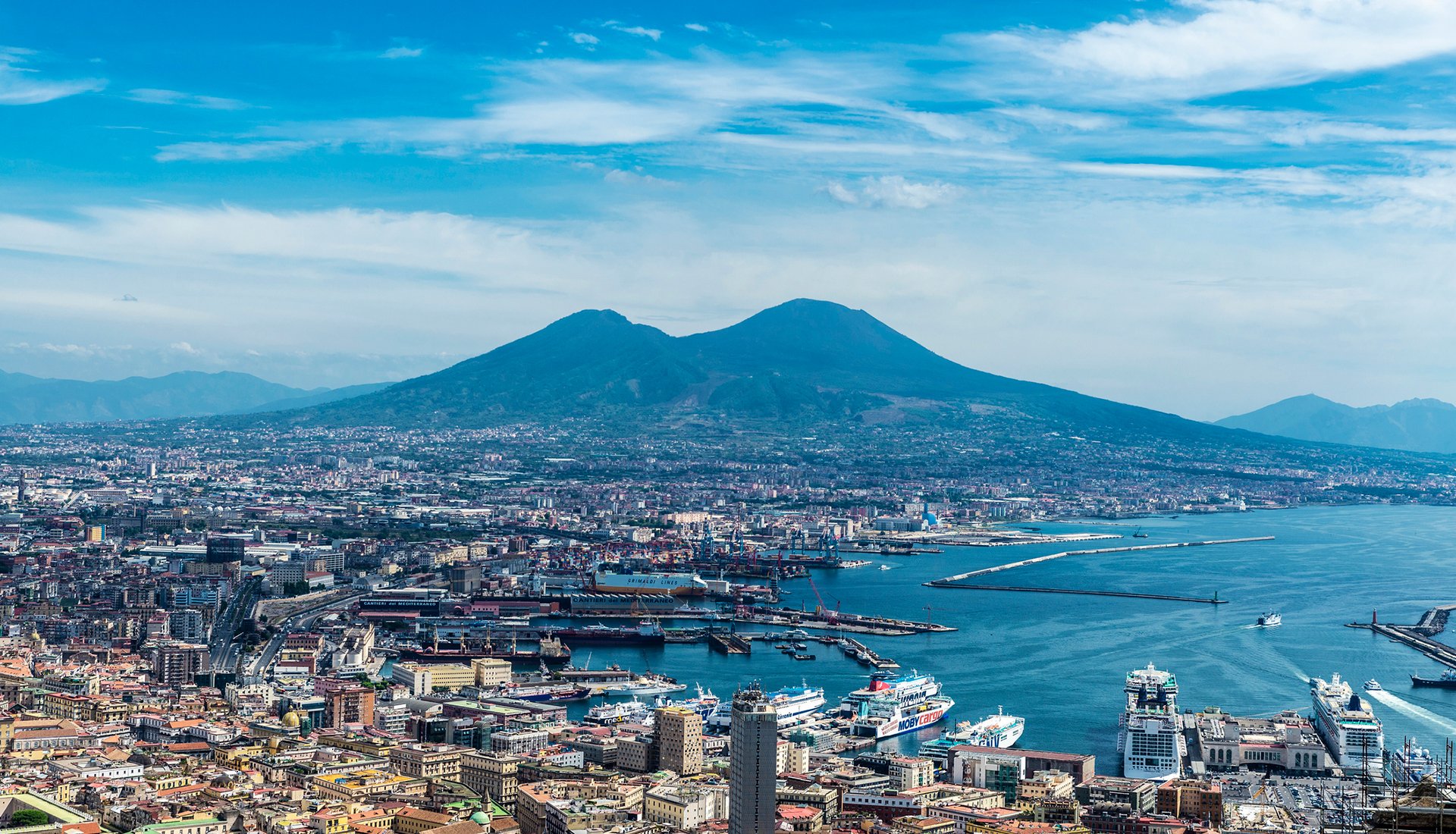 Aerial view of Naples city and port with Mount Vesuvius volcano dominating the skylin