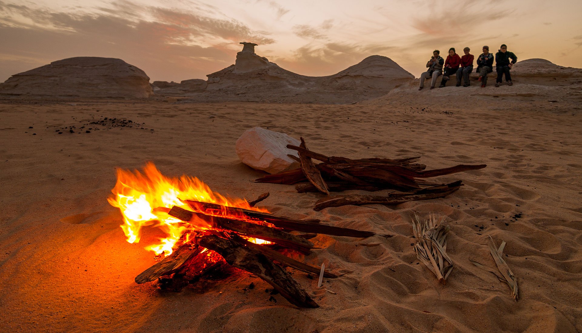 Desert bonfire at sunset Egypt Red Sea adventure experience with travelers gathered