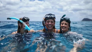 Three women snorkeling in clear Caribbean waters during luxury yacht charter vacation
