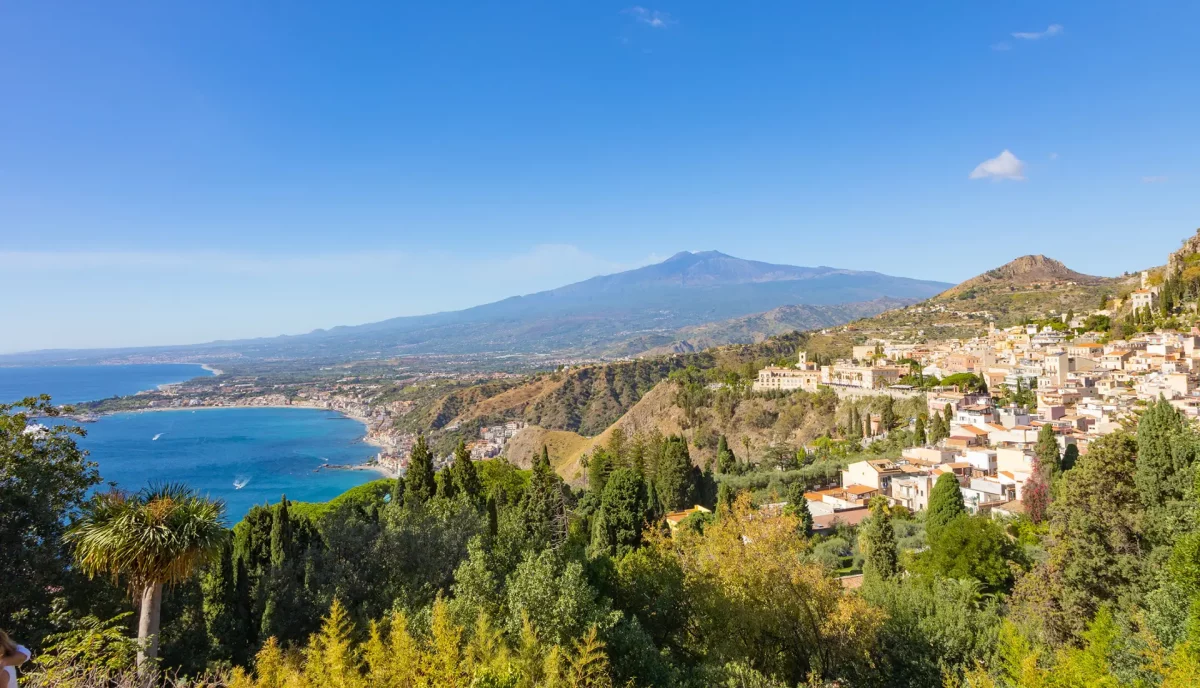 View from Taormina towards Mount Etna with Giardini Naxos bay and coastline belo