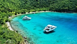 Aerial view of charter yachts anchored in turquoise water at Peter Island, British Virgin Islands