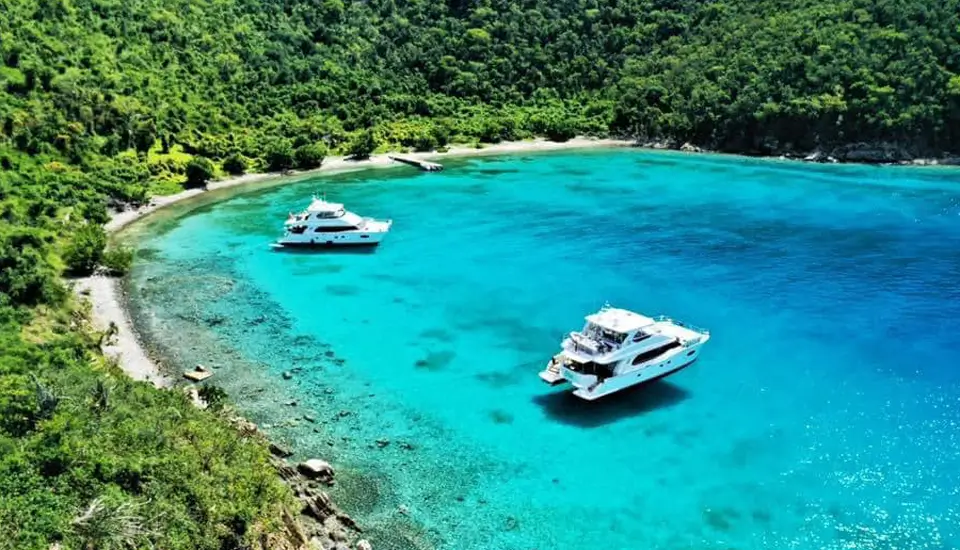 Aerial view of charter yachts anchored in turquoise water at Peter Island, British Virgin Islands
