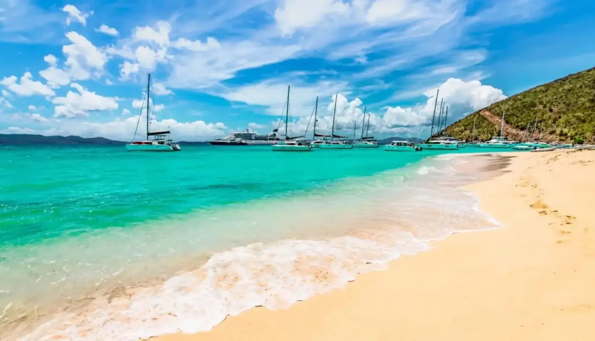 White Bay beach at Jost Van Dyke in the British Virgin Islands with charter yachts anchored in turquoise water