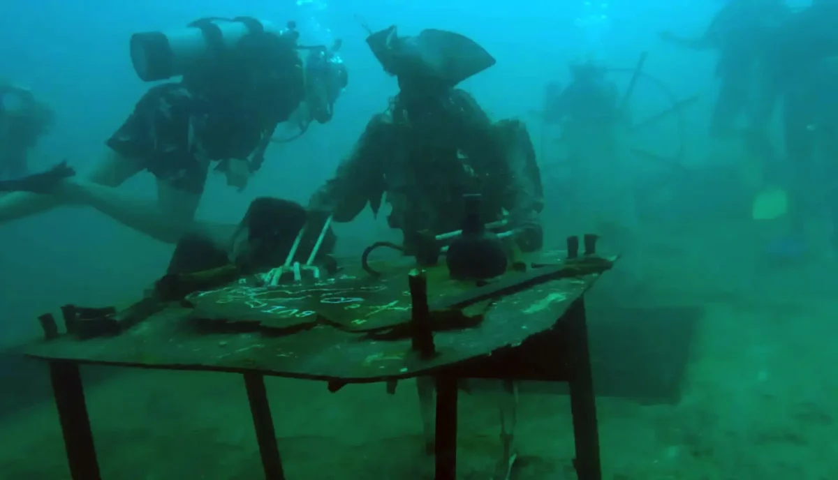 Scuba divers exploring the sunken Willy T pirate ship wreck at Key Bay, Peter Island, British Virgin Islands