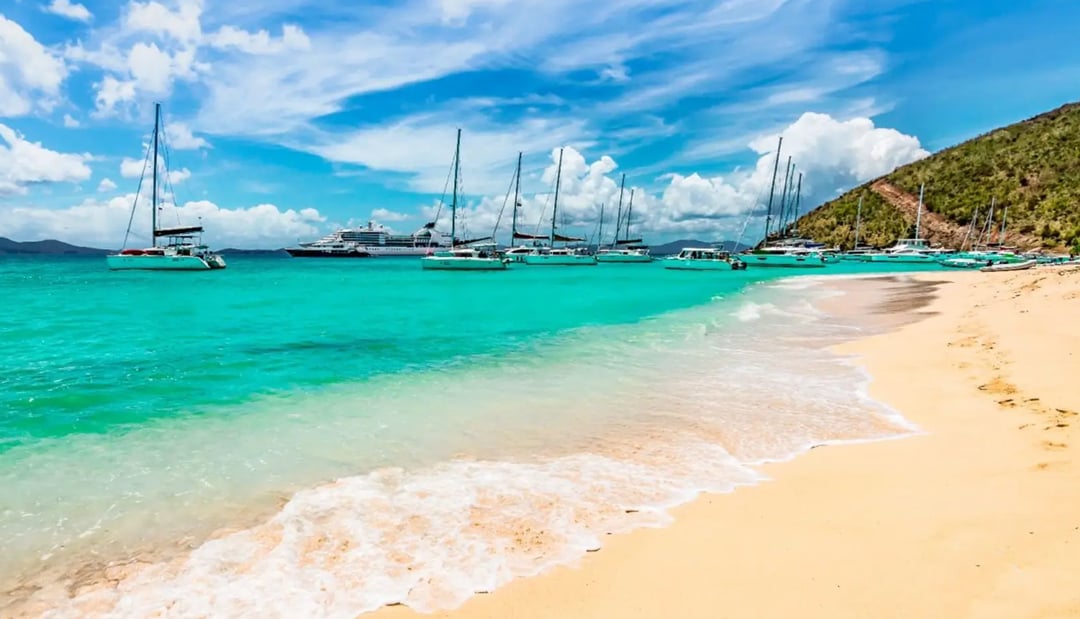 White Bay beach at Jost Van Dyke in the British Virgin Islands with charter yachts anchored in turquoise water
