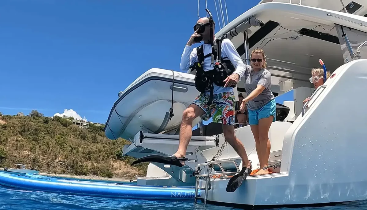 Scuba divers gearing up on the stern of a charter yacht in the British Virgin Islands