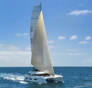 Amarea Lagoon 65 catamaran under full sail on open water — luxury crewed Greece yacht charter