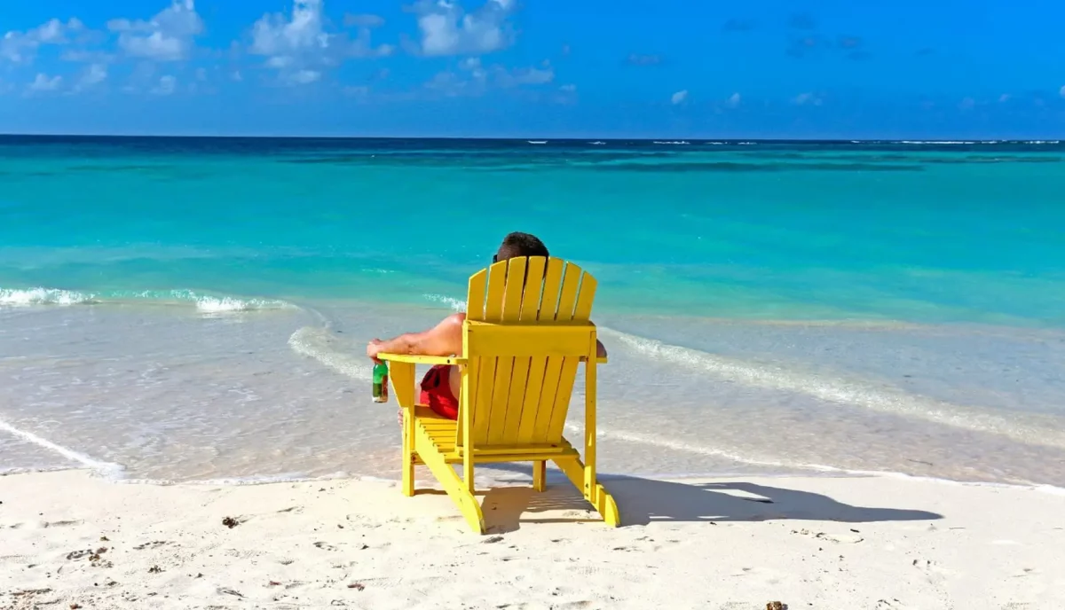 Yellow Adirondack chair on the white sand beach at Cow Wreck Beach Anegada BVI