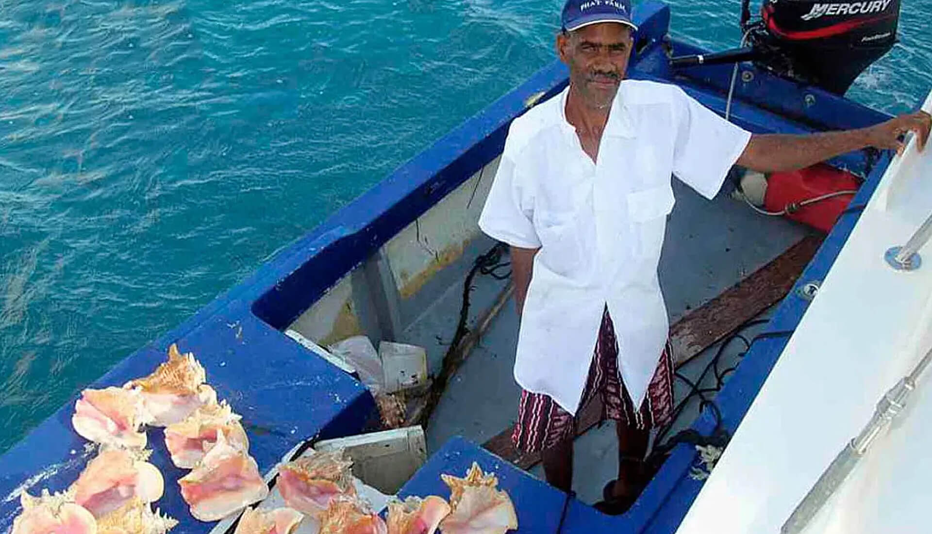 Local BVI fisherman with fresh conch in his boat