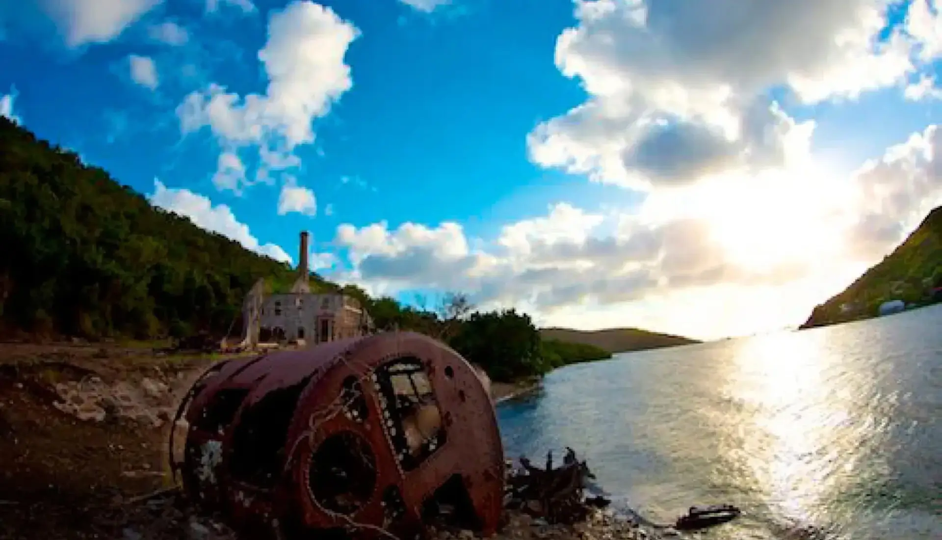 Rusted machinery from the historic Creque Marine Railway on Hassel Island, US Virgin Islands, at sunset