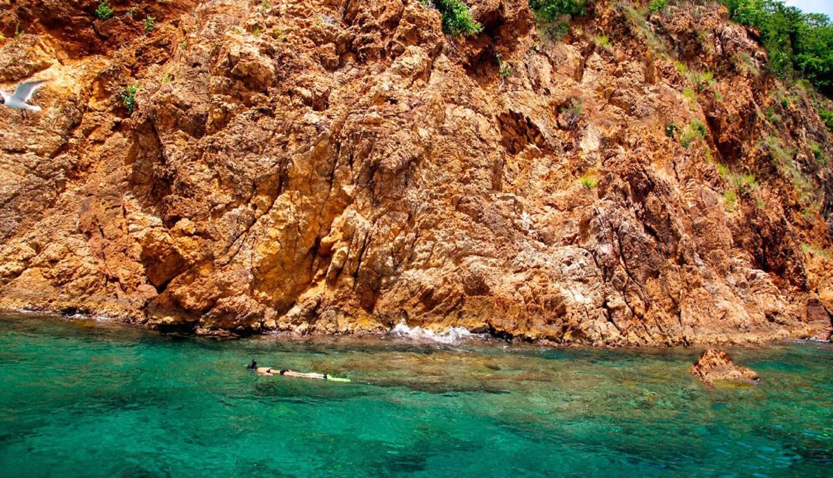 Snorkeller approaching the cave entrances at Treasure Point Norman Island BVI