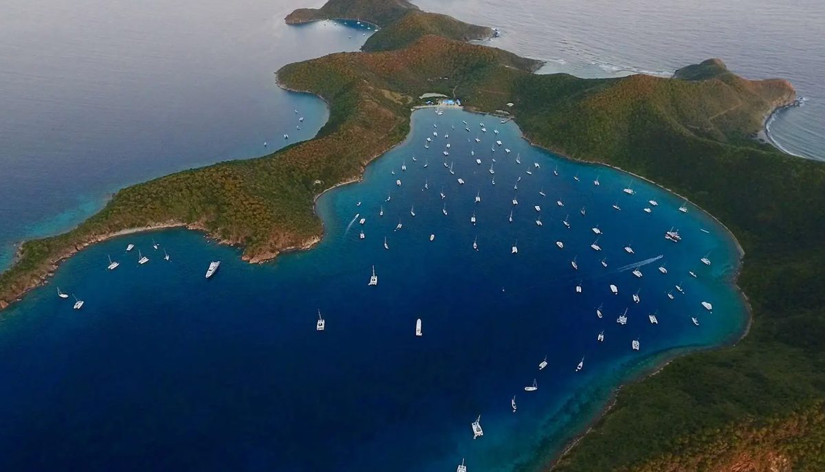 Aerial view of the Bight anchorage at Norman Island BVI packed with charter yachts