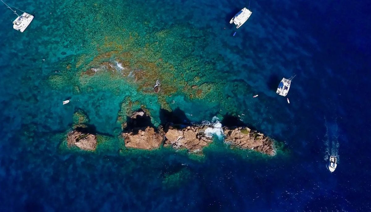 Aerial view of the Indians dive site off Norman Island in the British Virgin Islands with charter yachts on mooring balls