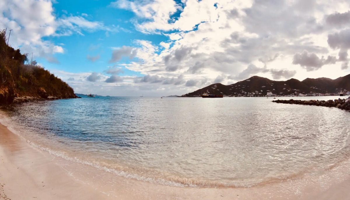 Baughers Beach on the south shore of Tortola BVI with dramatic cloud sky and calm turquoise water