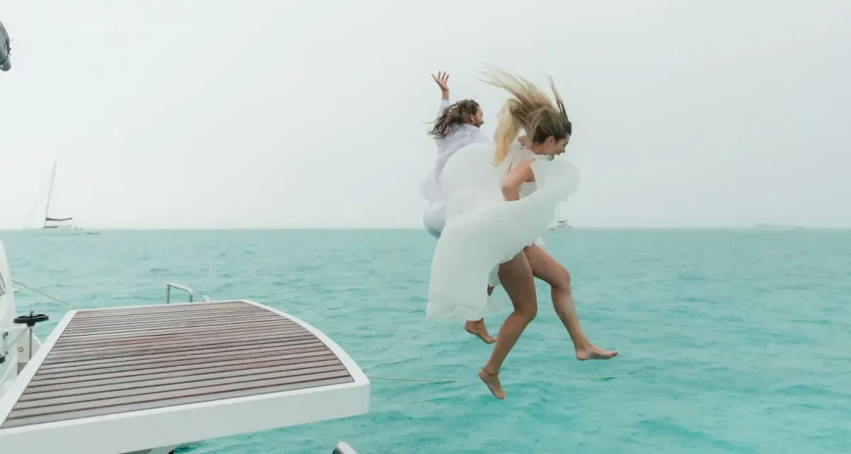bride and groom jumping off bahamas yacht