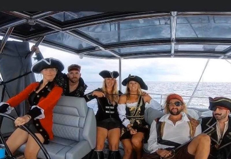 Guests dressed as pirates for theme night aboard an all-inclusive, crewed yacht charter.