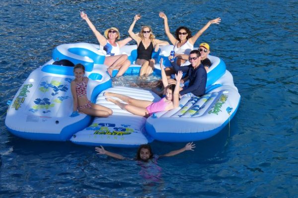 A family of 8 floating on a huge raft on an epic family vacation.