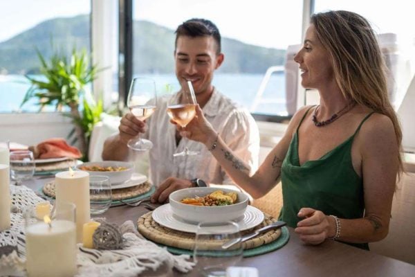 Dinner toast aboard Elysian Catamaran | Virgin Islands yacht charter lifestyle Guests enjoying a candlelit dinner toast aboard Elysian catamaran before their Virgin Islands yacht charter.