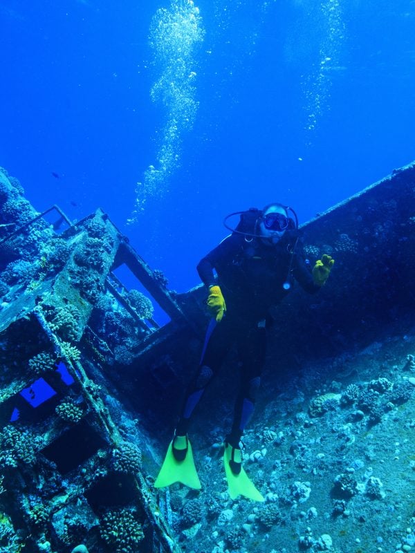 Scuba divers, wreck diving at a shipwreck.   Red Sea. Scuba Diver Point of View.