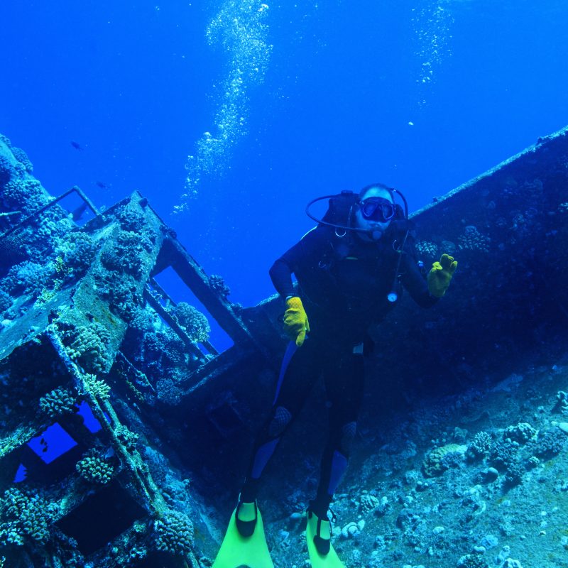 Scuba divers, wreck diving at a shipwreck.   Red Sea. Scuba Diver Point of View.