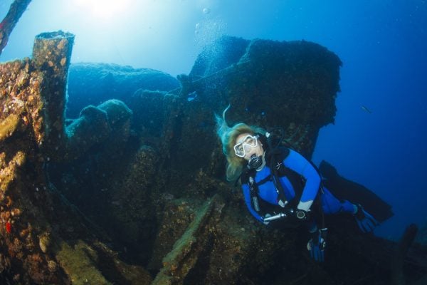 Scuba diving Exploring and enjoying Wreck diving over a shipwreck  Sea life  Sporting women