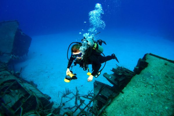 Diver photographing a Sunken Shipwreck in Cayman Brac